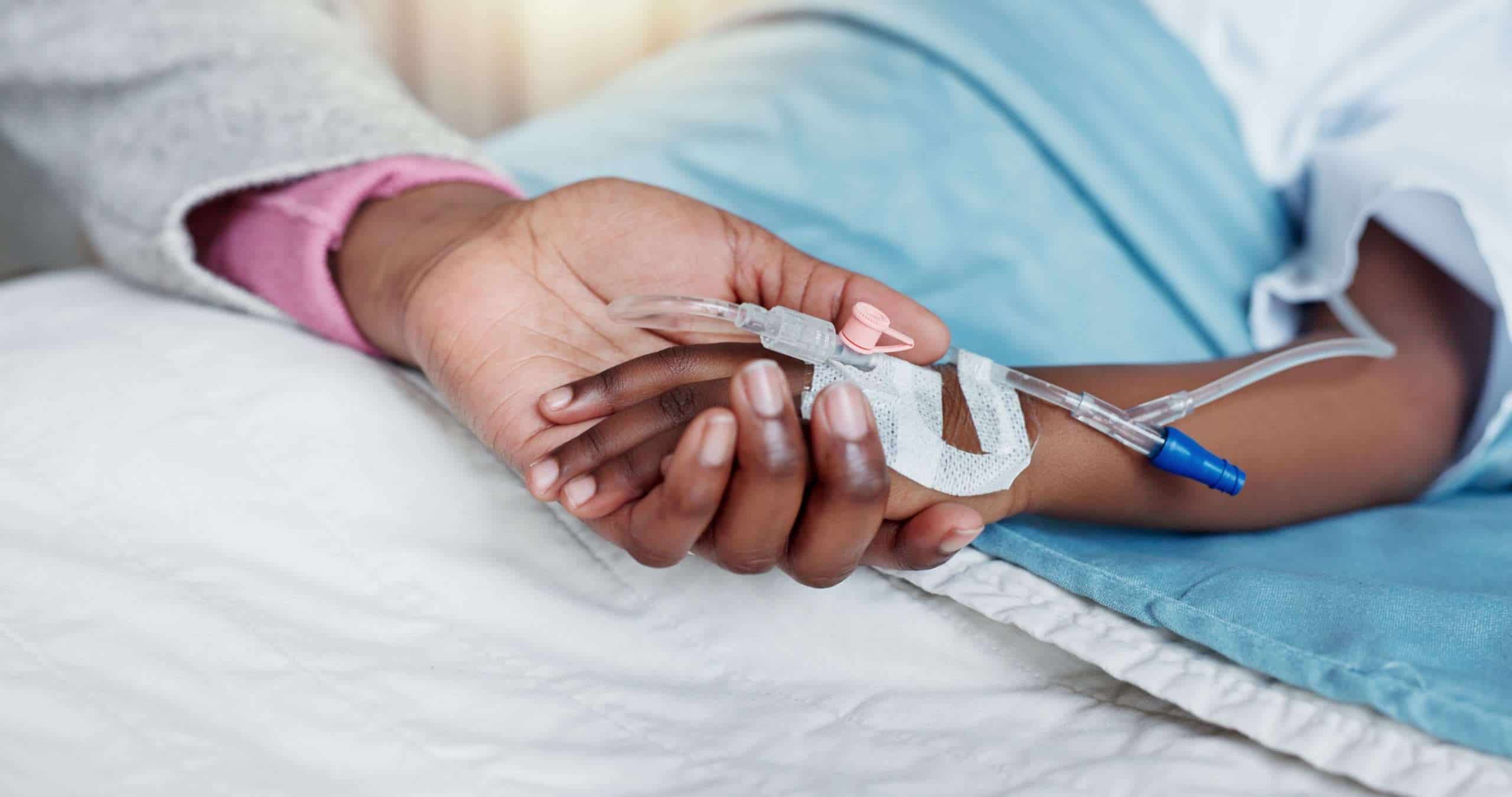 holding hands in hospital bed with medicine, medical therapy or IV drip
