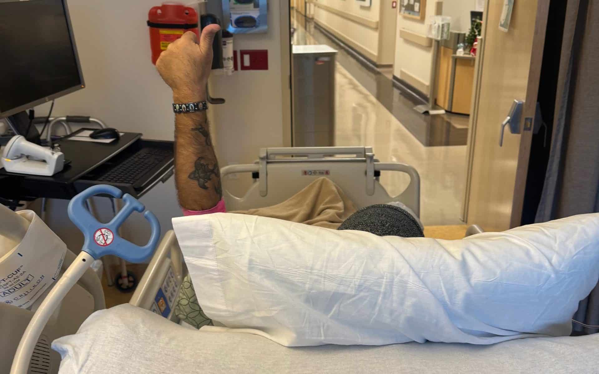 Johnathan giving a thumbs up from his hospital bed