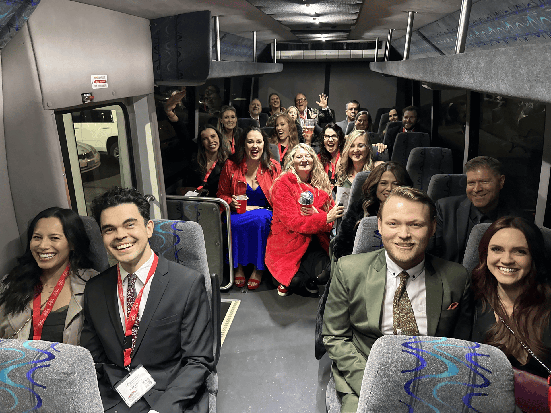 Group of dressed up people on a limo bus
