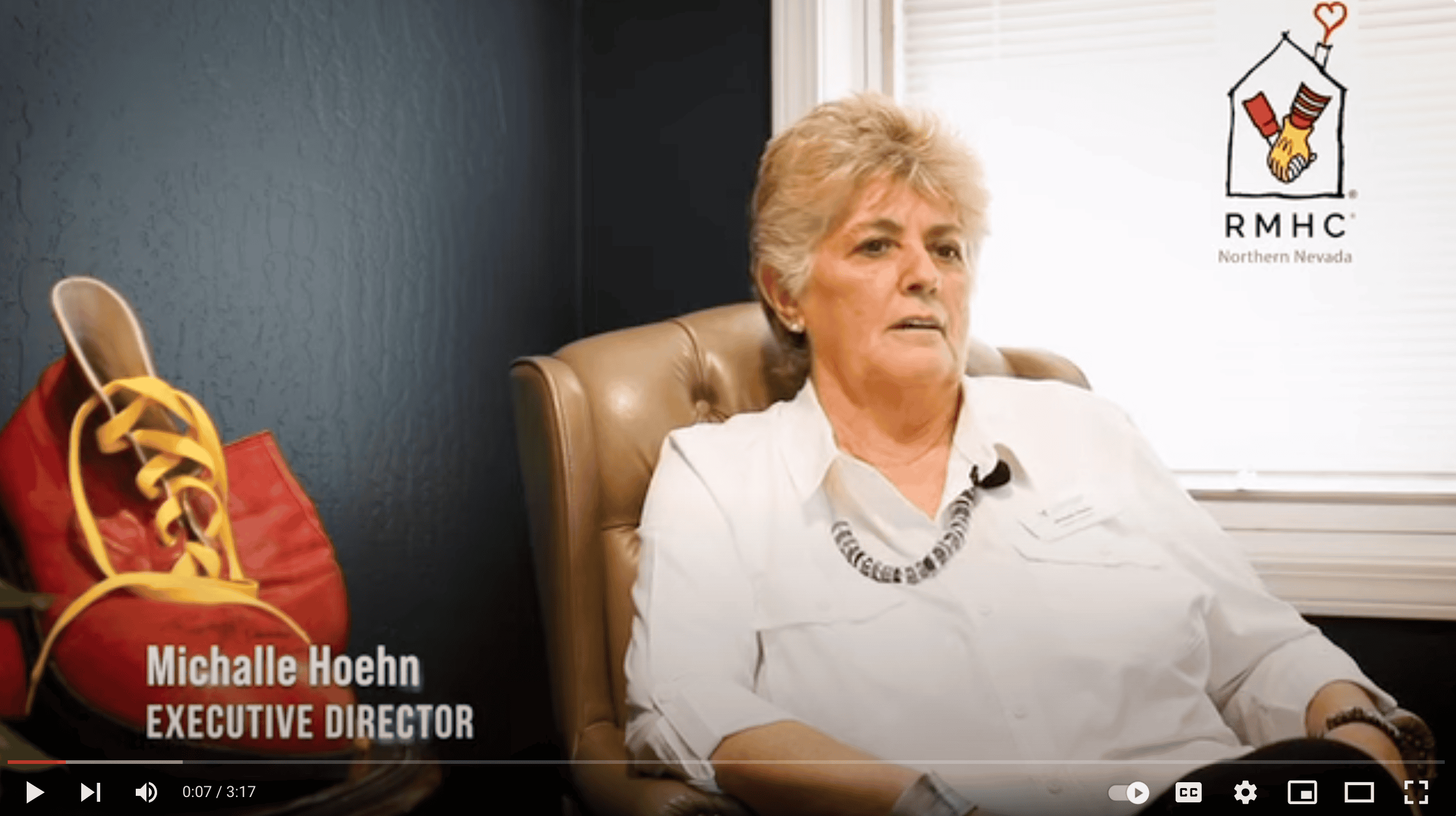 Michalle sitting in a chair talking ot the camera
