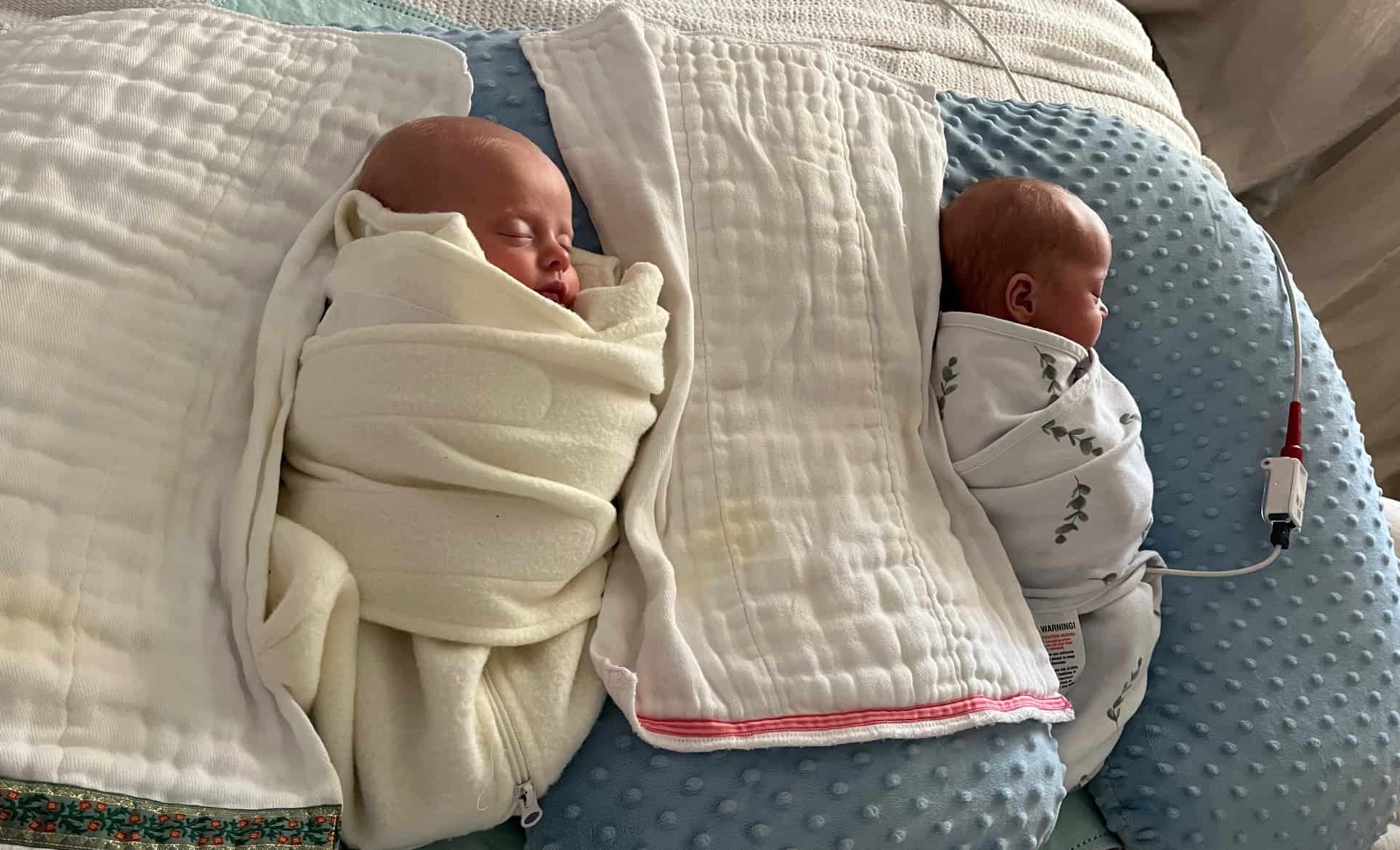 Twin babies wrapped in blankets in the NICU.